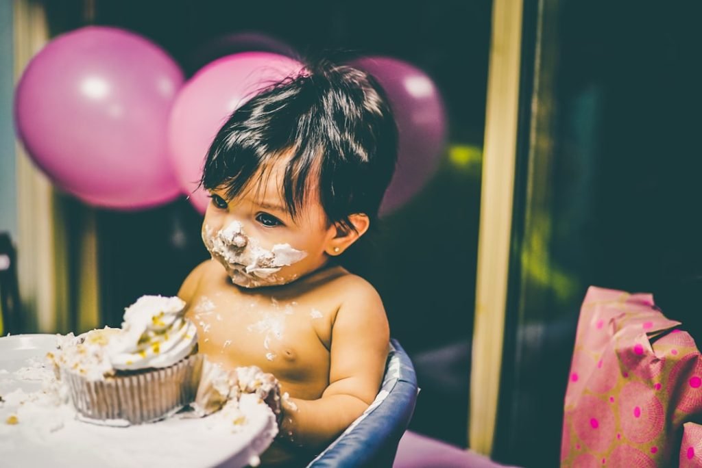 Young child experiencing sensory exploration during snack time