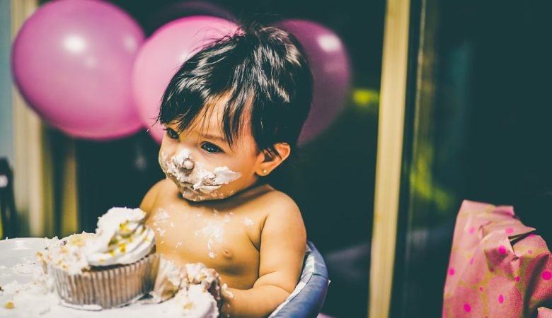 Young child experiencing sensory exploration during snack time